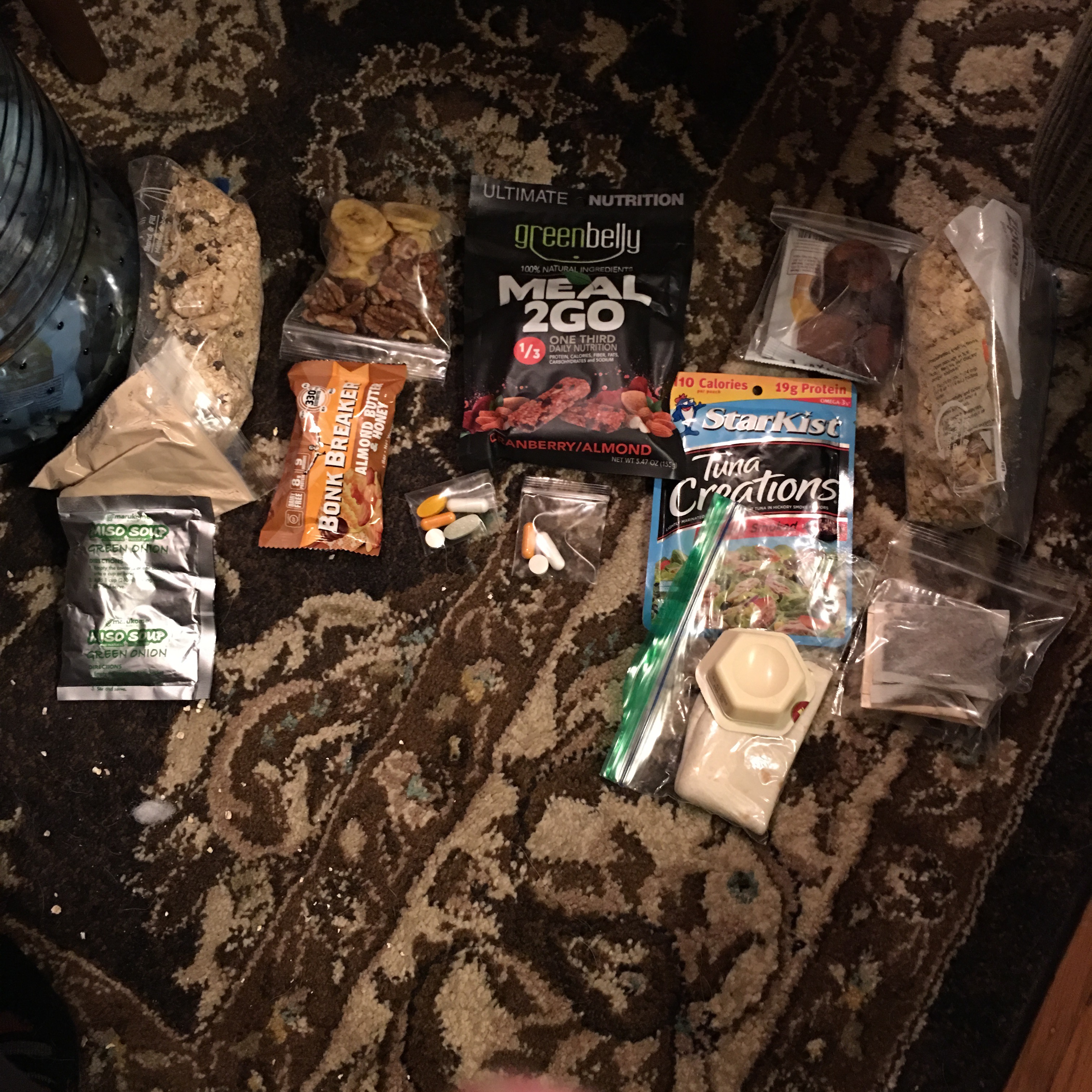 Photo of packaged food laid out for a backpacking trip meal